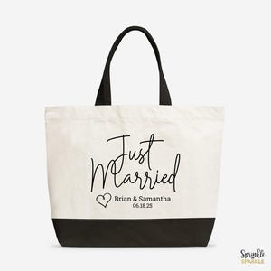 A Just Married Tote Bag. Wedding Tote bag is canvas white with a black base and handles. Customized with your names and wedding date on the bottom under the words just married and next to a cute heart. A great wedding gift.