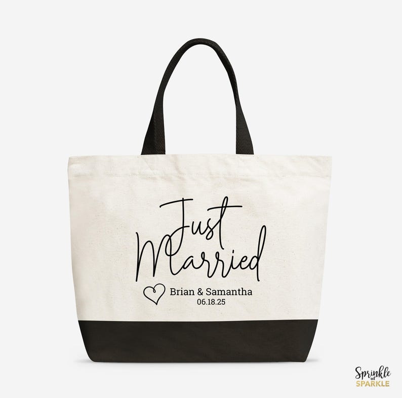 A Just Married Tote Bag. Wedding Tote bag is canvas white with a black base and handles. Customized with your names and wedding date on the bottom under the words just married and next to a cute heart. A great wedding gift.