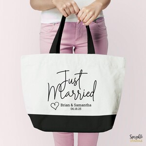 A Just Married Tote Bag. Wedding Tote bag is canvas white with a black base and handles. Customized with your names and wedding date on the bottom under the words just married and next to a cute heart. A great wedding gift.