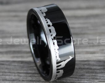 May include: A black ring with a silver animal silhouette design. The ring has a glossy finish and the text "Score Jewelry" is visible. The ring is set against a wooden background.