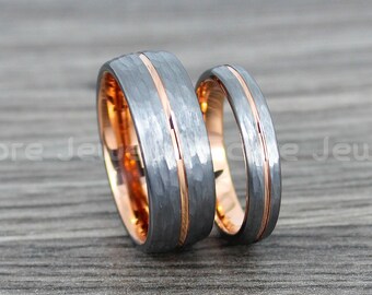 May include: Two tungsten carbide wedding bands with a hammered finish and rose gold inlay. The bands are stacked on top of each other.