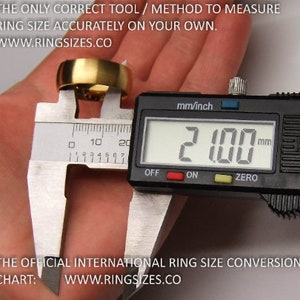 May include: A digital caliper measuring a gold ring. The caliper reads 21.00 mm. The text on the image reads "THE ONLY CORRECT TOOL / METHOD TO MEASURE RING SIZE ACCURATELY ON YOUR OWN. WWW.RINGSIZES.CO" and "THE OFFICIAL INTERNATIONAL RING SIZE CONVERSION CHART: WWW.RINGSIZES.CO"
