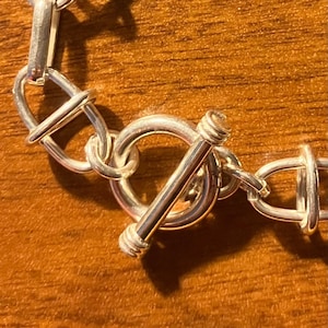 Sterling silver mariner link bracelet has a toggle clasp. Bracelet length is 8 inches. The weight is 16.3 grams.  BRL-6