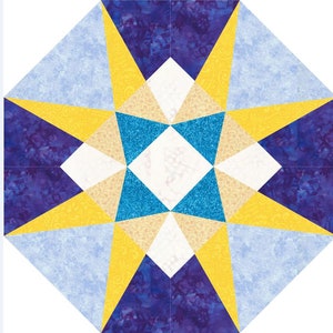 Può includere: Un blocco di trapunta con un disegno a stella in tonalità di blu, giallo e bianco. La stella è circondata da un bordo di tessuto blu e giallo.
