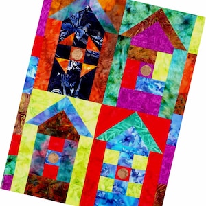Könnte beinhalten: Ein farbenfroher Quilt mit einem geometrischen Muster aus Häusern. Die Häuser sind aus verschiedenen Stoffen in Rot-, Grün-, Blau-, Gelb- und Lilatönen gefertigt. Der Quilt besteht aus Quadraten und Rechtecken, und die Häuser sind in einem Gittermuster angeordnet.