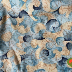 May include: Blue and beige fabric with a swirling, abstract pattern. The fabric has a textured, linen-like appearance.