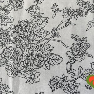 May include: Black and white floral pattern on a white background. The pattern features roses and leaves.