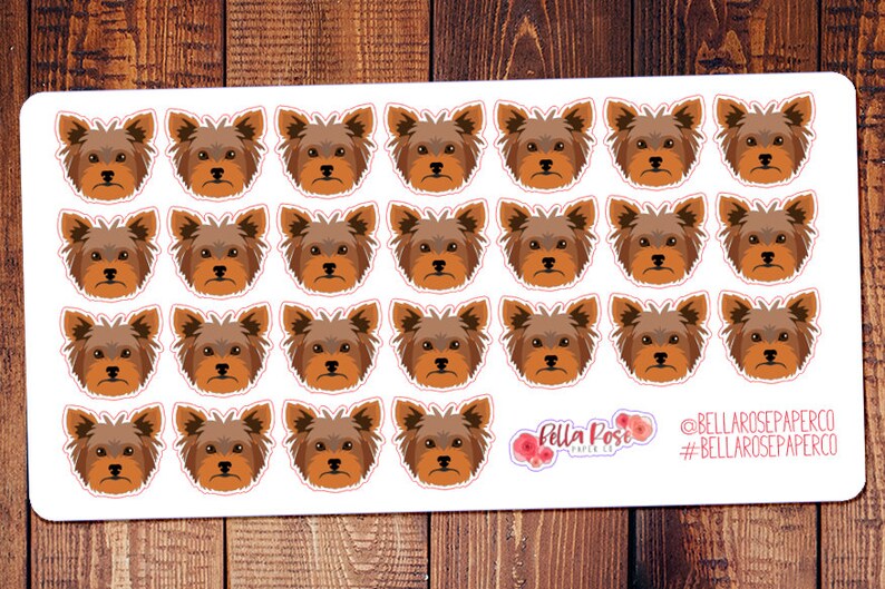 May include: A sheet of 24 brown and white Yorkshire Terrier dog stickers. The stickers are arranged in four rows of six stickers each. The stickers are on a white background. The text "Bella Rose Paper Co." and "#bellarosepaperco" is in the bottom right corner of the sheet.