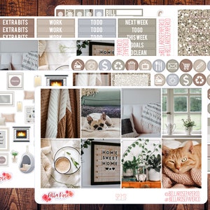 May include: A set of planner stickers featuring a cozy home theme. The stickers include images of a fireplace, a cat, a dog, a cup of coffee, plants, and a window. The stickers also include text such as "Home Sweet Home" and "Extra Bits".