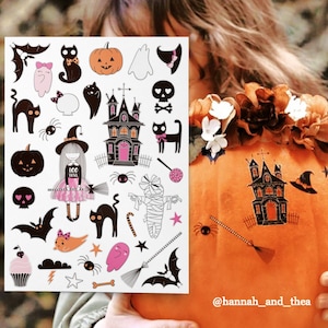 ガーリーなピンクのハロウィンの一時的なタトゥー転写。善良な魔女、黒猫、吸血コウモリ、頭蓋骨、カボチャ、幽霊の不気味でかわいいボディステッカー