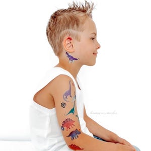 Boy Wearing Dinosaur Party Temporary Tattoos. Dino Birthday Favors. Body Stickers. Gifts For Kids.