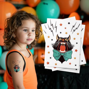 May include: A set of temporary Halloween tattoos featuring a black cat with a teal bow tie and lightning bolts. The tattoos are on a white background with orange and yellow stars.
