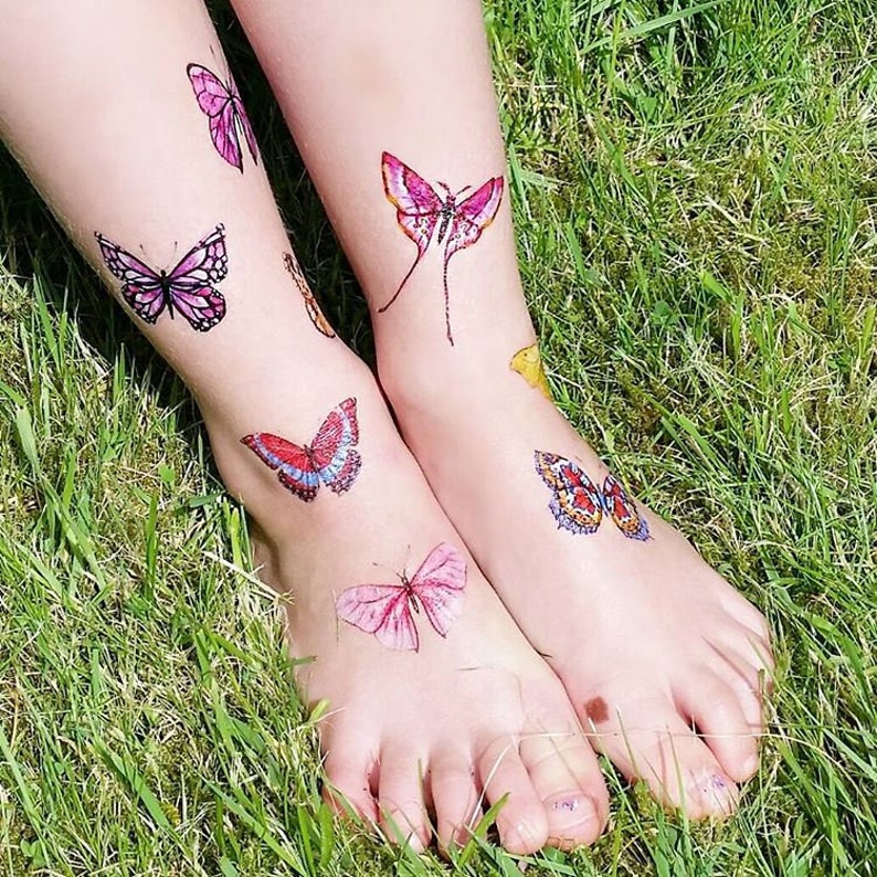 Girl wearing butterflies temporary tattoo transfers. Big set of 21 watercolor butterfly body stickers for kids.