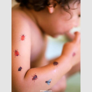 Kid wearing bugs temporary tattoo transfers. Set of 36 tiny beetles body stickers for kids.