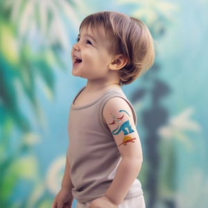 Boy Wearing Dinosaur Temporary Tattoos Set. Dino Birthday Party Activity and Favors.