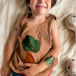 Boy Wearing Mother Earth Temporary Tattoo Transfers. Set of 3 Body Stickers. Earth Day Party Fake Tattoos To Promote Harmony With Nature.