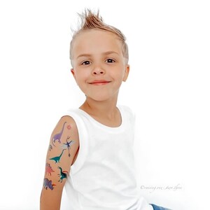 Boy Wearing Dinosaur Party Temporary Tattoos. Dino Birthday Favors. Body Stickers. Gifts For Kids.