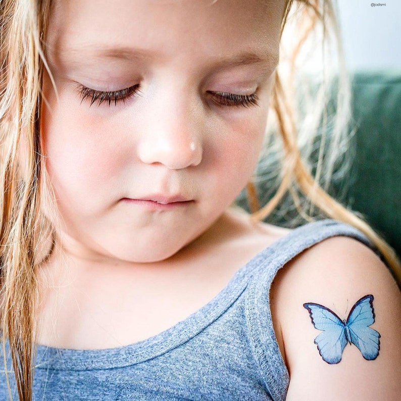 Girl wearing butterflies temporary tattoo transfers. Big set of 21 watercolor butterfly body stickers for kids.