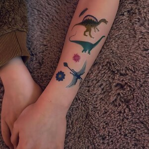 Boy Wearing Dinosaur Party Temporary Tattoos. Dino Birthday Favors. Body Stickers. Gifts For Kids.