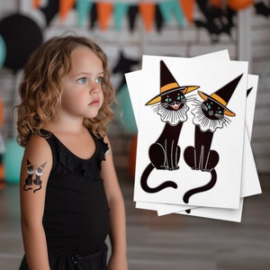 May include: Two black cats wearing witch hats and collars with a white background. The cats have yellow hats, blue eyes, and white collars. The cats are sitting and looking forward.