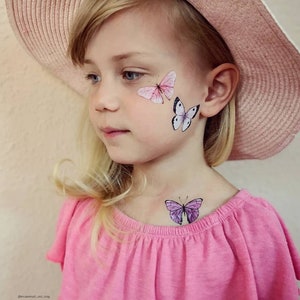 Girl wearing butterflies temporary tattoo transfers. Big set of 21 watercolor butterfly body stickers for kids.