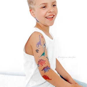 Boy Wearing Dinosaur Party Temporary Tattoos. Dino Birthday Favors. Body Stickers. Gifts For Kids.