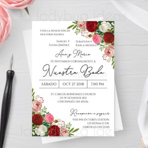 May include: A white wedding invitation with floral accents in red, pink, and green. The invitation includes the text "Ana y Maria Te invitamos cordialmente a Nuestra Boda" and event details.