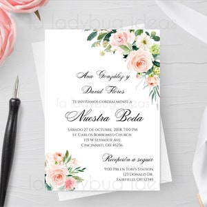 May include: A white wedding invitation with floral accents and elegant script. The invitation includes the names Ana González and David Flores, along with wedding details. Pink roses and greenery decorate the corners. A calligraphy pen is on the left.