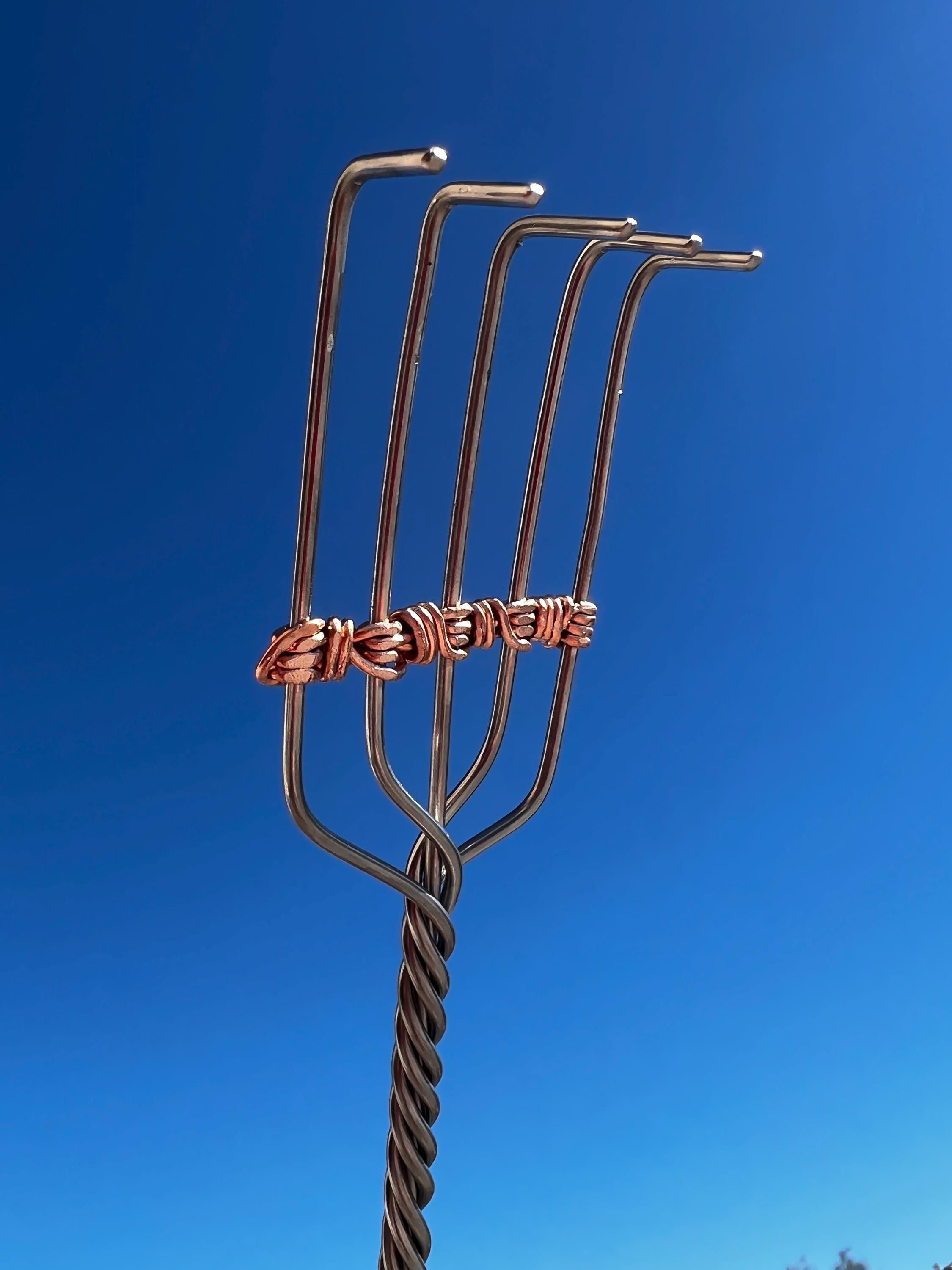 Fingers, a stainless steel back scratcher with serial number and lifetime warranty