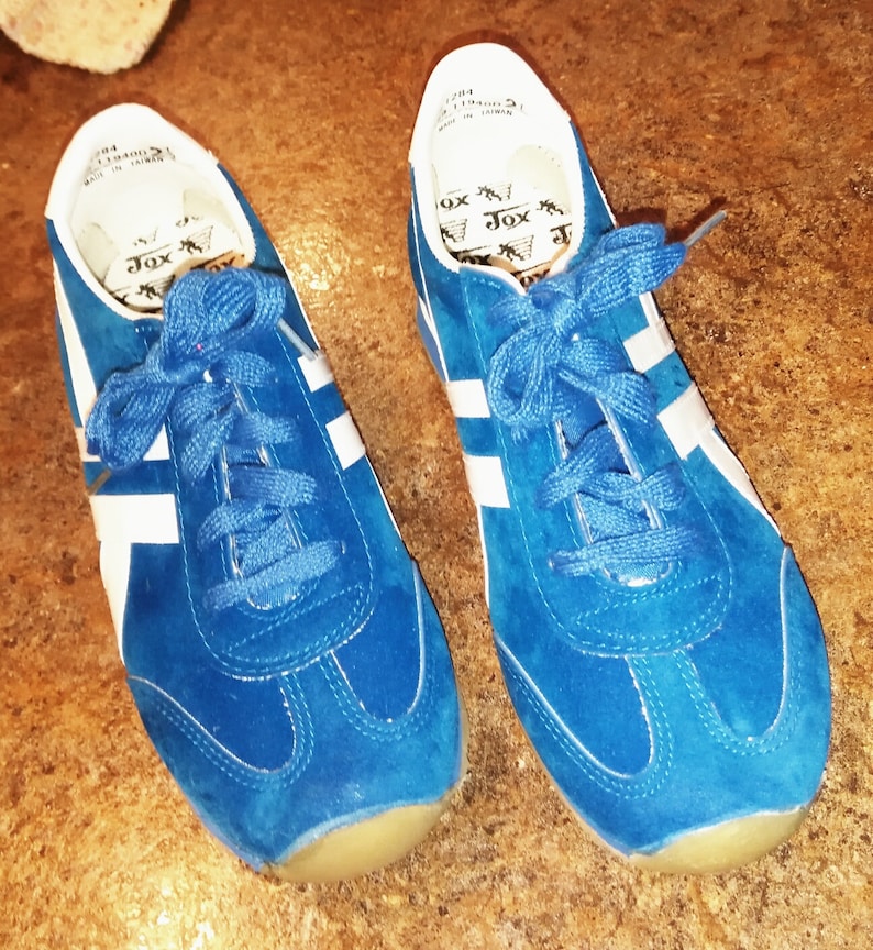 Bright blue tennis shoe. All manmade material.Blue suede Bright blue tennis shoe. All manmade material.Blue suede