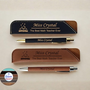 May include: A set of personalized pens and pen cases. The black pen case has the text "Miss Crystal" and "The Best Math Teacher Ever". The brown pen case has the same text. The pens are black and brown.