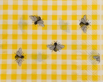 May include: Yellow and white gingham fabric with a repeating pattern of black bees.