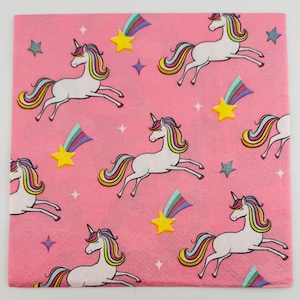 May include: Pink square paper napkin with a repeating pattern of white unicorns with rainbow manes and tails, yellow stars, and shooting stars. The unicorns are in a running pose, and the stars are in various sizes.