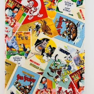 May include: A colorful fabric featuring a collage of vintage Walt Disney cartoon images featuring Donald Duck, Chip and Dale, and other characters. The fabric is a mix of red, yellow, blue, and green.
