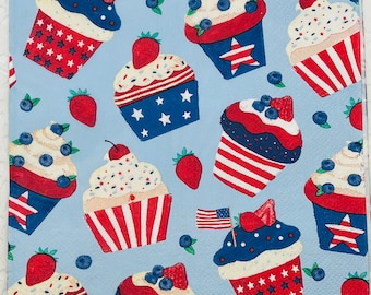 May include: A blue background with a repeating pattern of red, white, and blue cupcakes with white frosting and sprinkles. The cupcakes have red and white stripes and blue and white stars.