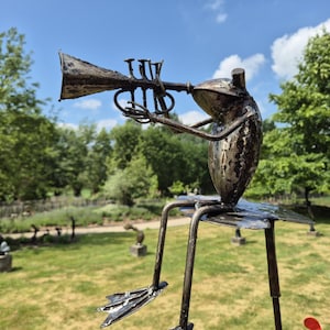 Frog sculptures on a stick, frog orchestra, different music instruments,  unique and whimsical garden sculpture, made from oil drums