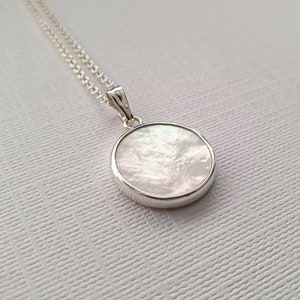 White mother of pearl and sterling silver coin pendant