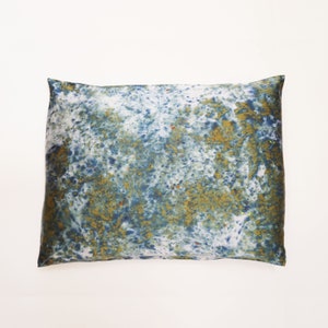 May include: A blue and gold decorative pillow with a marbled pattern.