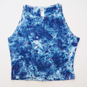 May include: A blue and white tie-dye crop top with red speckles.
