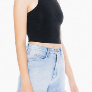 May include: A black sleeveless crop top with a high neckline. The top is made of a soft, stretchy fabric and has a relaxed fit.