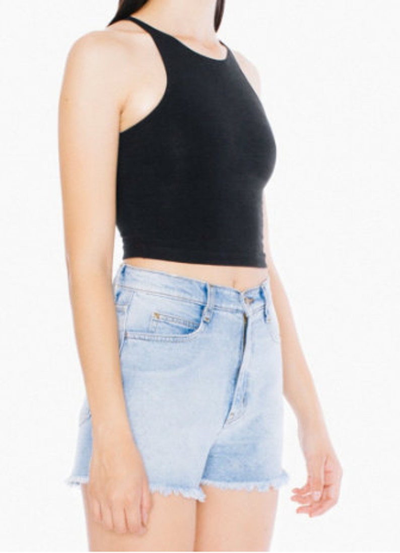 May include: A black sleeveless crop top with a high neckline. The top is made of a soft, stretchy fabric and has a relaxed fit.