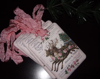 May include: Set of vintage-style Christmas gift tags featuring a reindeer pulling a sleigh with a Christmas tree. The tags are printed with the text "FRERES PARIS 1802" and "JOYEUX NOEL".