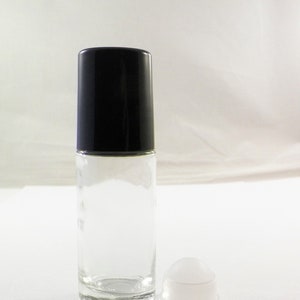 May include: A clear glass roll-on bottle with a black cap and a white roll-on ball. The bottle is empty and ready to be filled with your favorite essential oil or fragrance.
