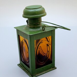 A vintage European whiskey bottle in the shape of a cerosin lamp