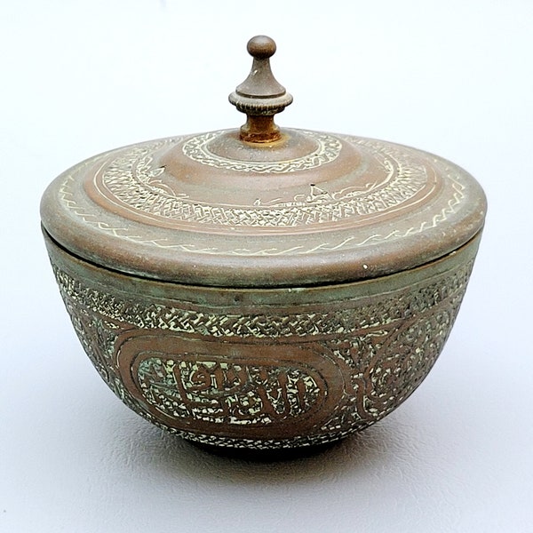 Small Islamic antique copper pill box covered with Arabic phrases and ornaments. Patina.