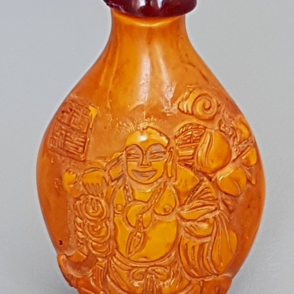 Vintage dark yellow Chinese cinnabar snuff bottle with Buddha emboss on it