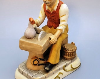 Vintage Bisque figurine of an old man sharping knives. unmarked