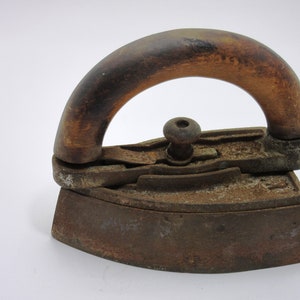 Antique rusty iron with wooden handle and wooden knob