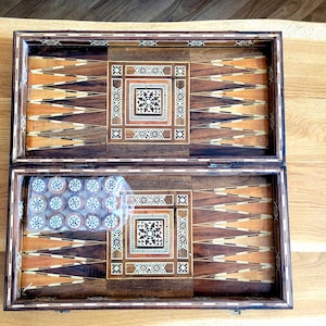 Puede incluir: Una taza de cerámica blanca con un asa negra y el texto "But First, Coffee" en negro, con una fuente de estilo manuscrito. La taza está sobre una superficie blanca.