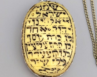 Antique amulet pendant "Shema Israel", written in "Sofer Stam"  script, on a yellowish hard base.